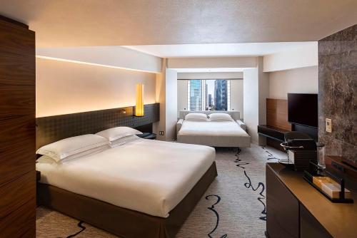 a hotel room with two beds and a television at Hilton Tokyo Hotel in Tokyo