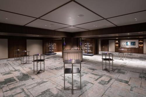 a large room with tables and chairs in a building at Hilton Tokyo Hotel in Tokyo