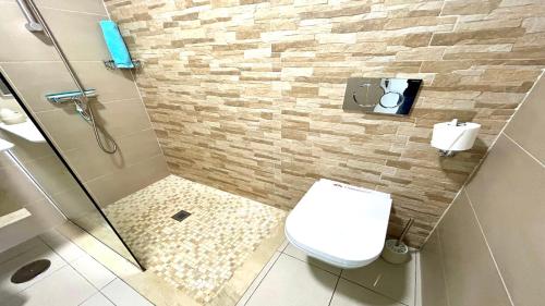 a bathroom with a shower with a toilet and a sink at Welooveyou Casa Ocean View in Costa Calma