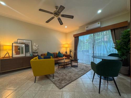 a living room with a couch and a ceiling fan at View Talay Longstay in Jomtien Beach