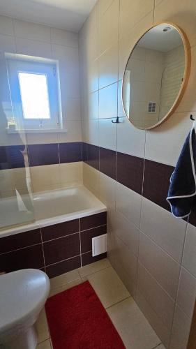 a bathroom with a tub and a sink and a mirror at Spokojne i miłe miejsce na Mazurach, nowe po remoncie in Kętrzyn