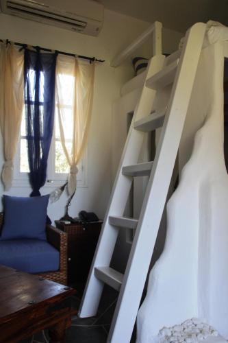 a bunk bed with a ladder in a room at Giannakas Studios in Platis Yialos Sifnos