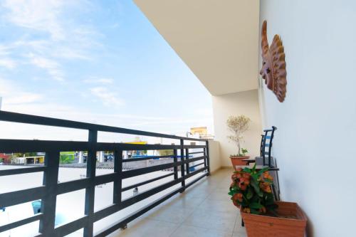 a balcony with a black railing and a view of the water at Hotel Nápoles in Ciudad Obregón
