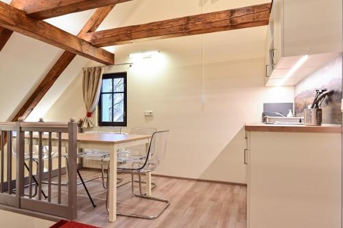 a kitchen and dining room with a table and chairs at Apartmány Christian in Karlovy Vary