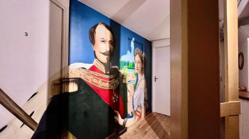 a painting of a portrait of a man on a wall at Coliving Ajaccio in Ajaccio