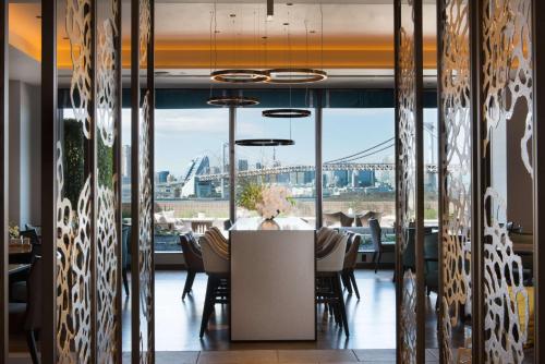 a dining room with a table and a view of the bridge at Hilton Tokyo Odaiba in Tokyo