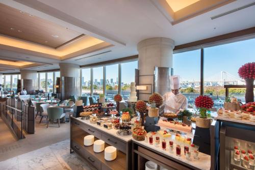 a buffet at a hotel with a chef in the middle at Hilton Tokyo Odaiba in Tokyo