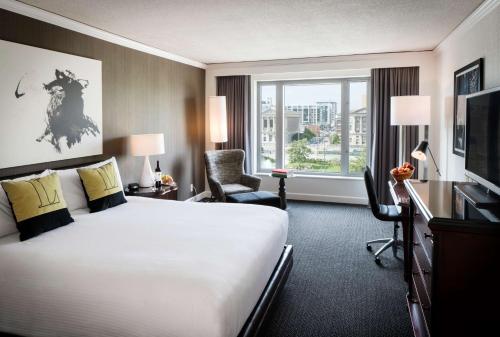 a hotel room with a large bed and a window at The Logan Philadelphia, Curio Collection by Hilton in Philadelphia