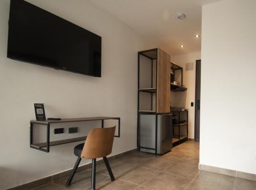 a living room with a flat screen tv on the wall at Apartahotel con Piscina in Medellín