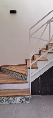 a set of stairs in a room with a white wall at Casa Ramos Salamanca - Airport pick up and drop off service - Homestay in Lima