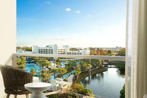 a balcony with a view of a river and buildings at Hilton Orlando Buena Vista Palace - Disney Springs Area in Orlando