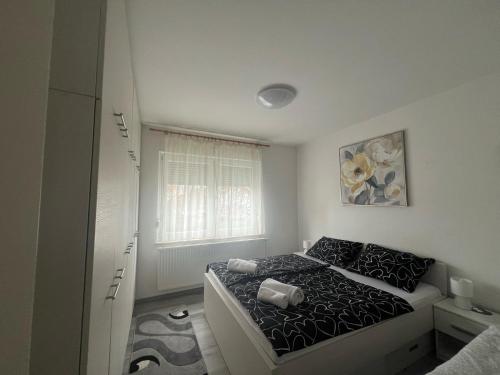 a bedroom with a bed and a window at CENTRUM with private parking in Virovitica
