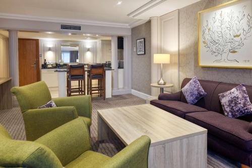 a living room with a couch and chairs and a table at DoubleTree by Hilton Glasgow Central in Glasgow