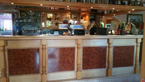 a bar with a large wooden counter top at Hotel Al Cavallino in Arnstorf