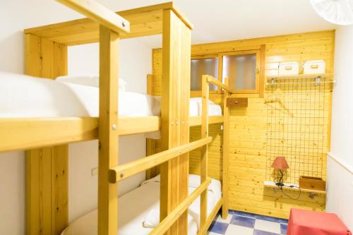 a room with three bunk beds and a bathroom at Casa Levante - Casa Rural Los Cuatro Vientos in Moratalla
