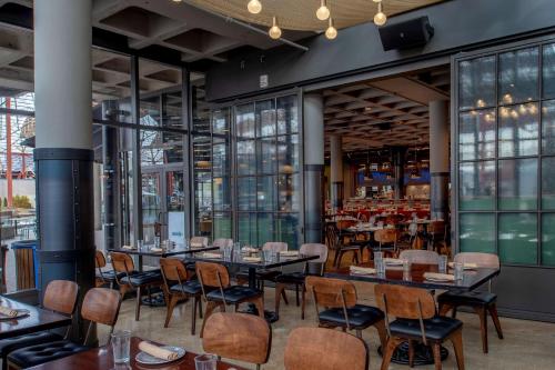 a restaurant with tables and chairs and windows at St. Louis Union Station Hotel, Curio Collection by Hilton in Saint Louis