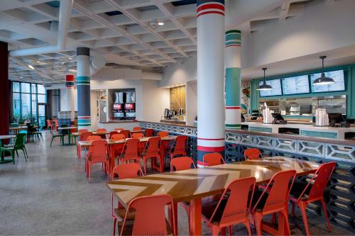 a restaurant with tables and chairs and a counter at St. Louis Union Station Hotel, Curio Collection by Hilton in Saint Louis