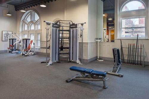 a gym with several treadmills and equipment in a room at St. Louis Union Station Hotel, Curio Collection by Hilton in Saint Louis
