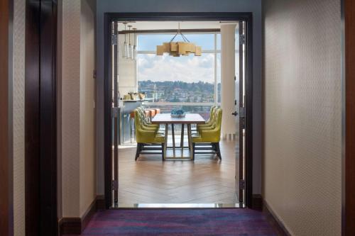 a dining room with a table and yellow chairs at Embassy Suites By Hilton Seattle Downtown Pioneer Square in Seattle
