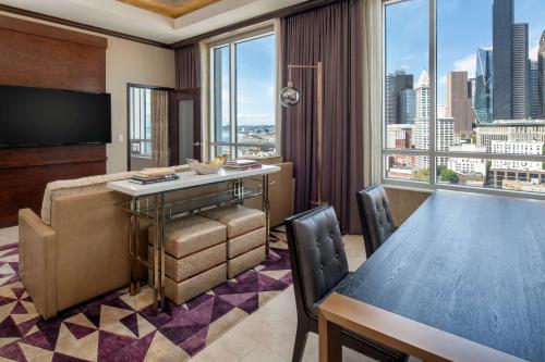 a hotel room with a table and a large window at Embassy Suites By Hilton Seattle Downtown Pioneer Square in Seattle