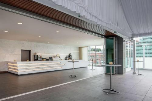 a lobby of a building with a kitchen in it at Embassy Suites By Hilton Seattle Downtown Pioneer Square in Seattle