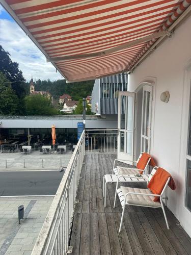 a porch with a bench and awning on a building at Bergkristall Apartment in Pörtschach am Wörthersee