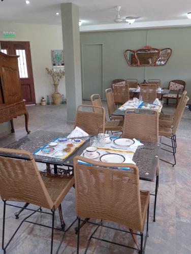 a group of tables and chairs with plates on them at La Puerta de Cachi in Cachí