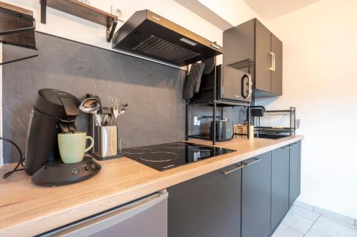 a kitchen with a counter top with a coffee maker at Atelier ambré in Denain