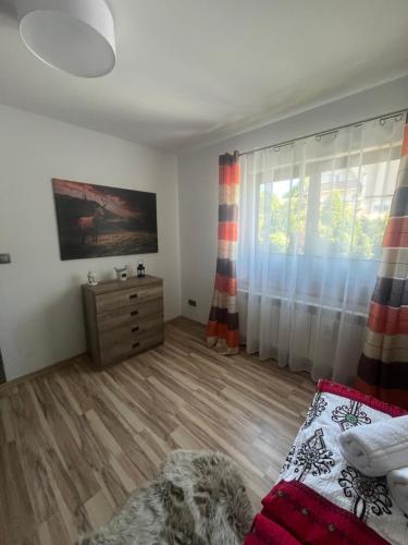 a bedroom with a bed and a dresser and a window at Polanki u Anki in Zawoja