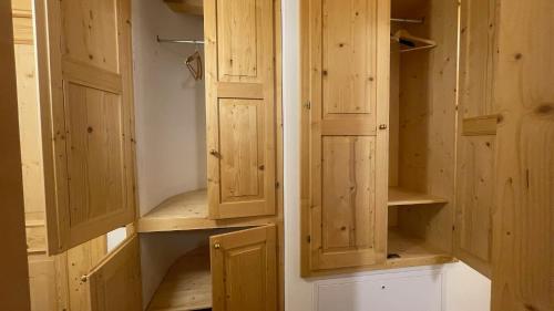 a pair of wooden cabinets in a room at Appartamenti Bion in Levico Terme
