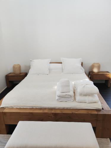 - un lit avec des draps et des oreillers blancs dans l'établissement La Maison joyeuse à 5 minutes d'Uzès, à Montaren-et-Saint-Médiers