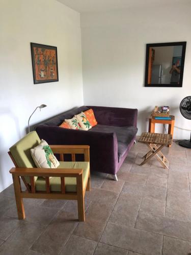 a living room with a couch and a table at CasaCalypso Grenada in Belmont