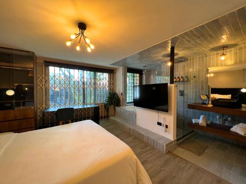 a bedroom with a bed and a flat screen tv at Loft Apartamentos Lleras in Medellín
