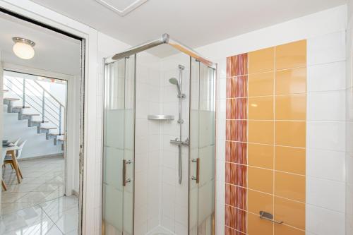 a glass shower door in a bathroom with a staircase at JARDINS DE MONACO - Vue Mer - Jacuzzi - Parking in Cap d'Ail