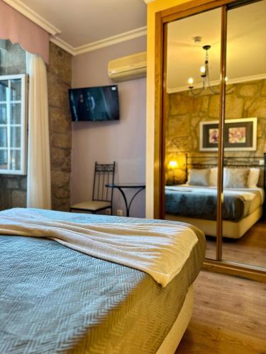 a bedroom with a bed and a large mirror at Residencial Bem Estar in Chaves