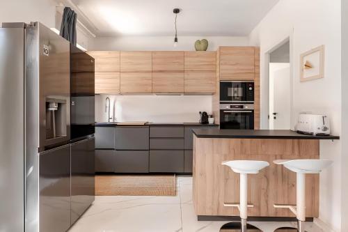 a kitchen with wooden cabinets and stainless steel appliances at Latina Modern Apartment in Latina