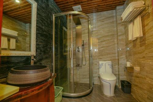 a bathroom with a shower and a toilet at Zhangjiajie Mountainside in Zhangjiajie