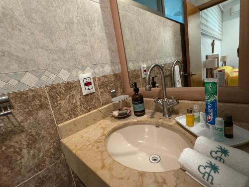 a bathroom with a sink and a mirror at Casa Mismaloya Selva in Cedro