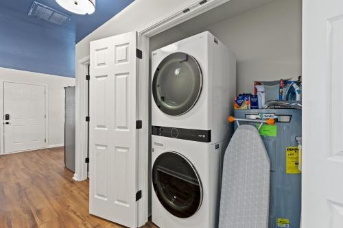 a washer and dryer in a laundry room at The Luxe Hot Tub Playground 12 Min to Horse Park in Georgetown