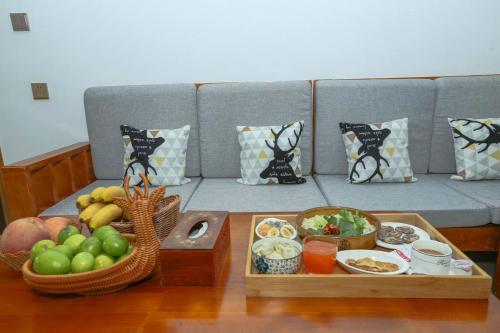 a coffee table with bowls of food on a couch at Zhangjiajie Mountainside in Zhangjiajie