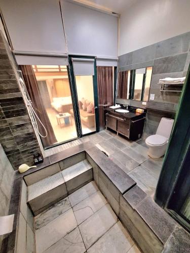 a bathroom with a toilet and a sink at Valentine湯屋 in Jiaoxi