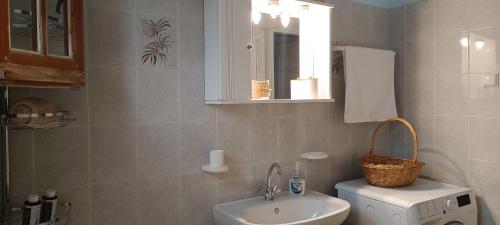 a bathroom with a sink and a toilet and a mirror at Tria Liodendra Corfu - Sea in Petrití