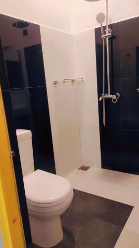 a bathroom with a toilet and a shower at Noble Sight in Anuradhapura
