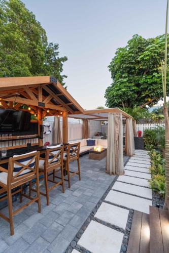 a patio with a wooden gazebo and chairs at Sombrero Reef Light Suite in Key West