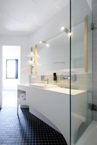 a bathroom with a sink and a mirror at Hôtel Belvue in Brussels