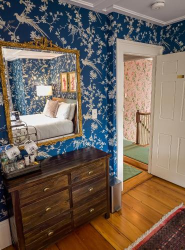 a bedroom with a bed and a mirror on the wall at Sally Webster Inn in Rockport