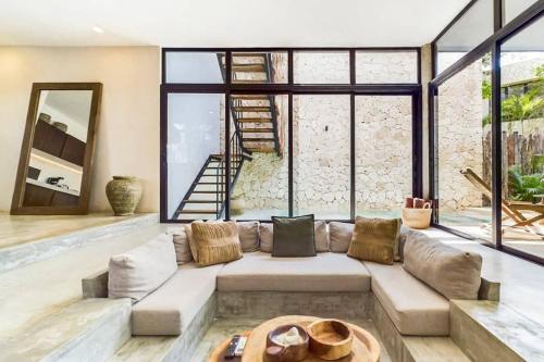 a living room with a couch and a table at Boho Jungle Villa -Pvt Pool -Concierge-Hammock 7B in Tulum