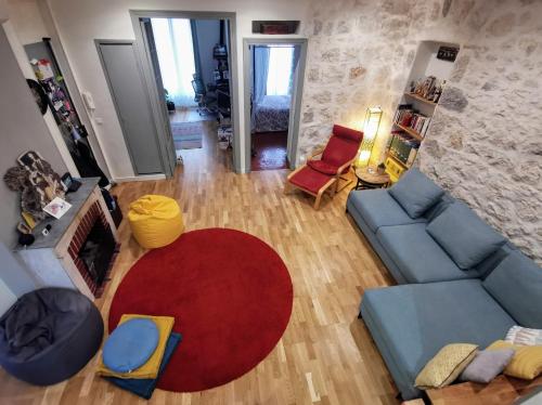 - un salon avec un canapé bleu et un tapis rouge dans l'établissement Our home, Cozy Apartment two minutes from the sea - Clima, à Nice