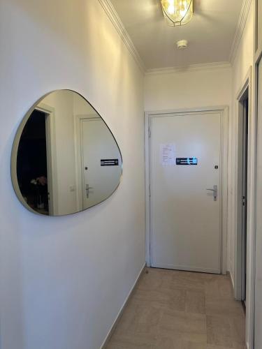 a hallway with a mirror and a white door at Maison Blanc in Monte Carlo
