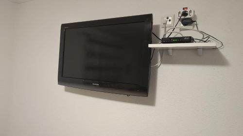 a flat screen tv hanging on a wall at Apartment Gradina in Korenica